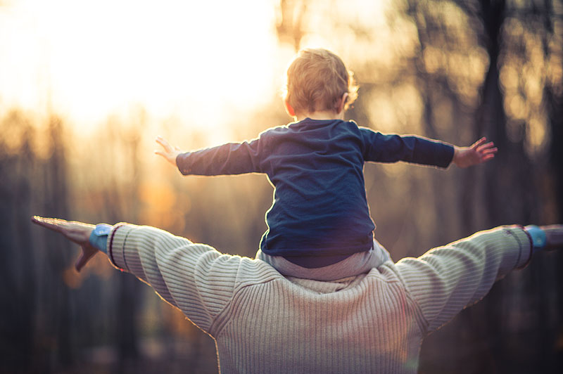 Child on father's shoulders